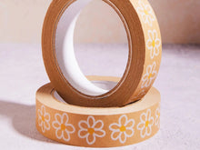 Load image into Gallery viewer, Two rolls of brown tape with white floral designs on a light background