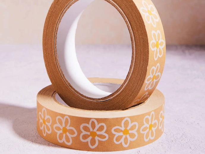 Two rolls of brown tape with white floral designs on a light background