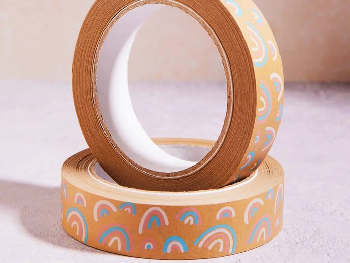 Two rolls of decorative tape with rainbow patterns on a light background