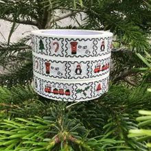 Load image into Gallery viewer, A white ceramic Christmas wreath-shaped candle holder or planter with a festive pattern of red Santa clowns, penguins, candy canes, and Christmas trees, nestled in green pine branches.

